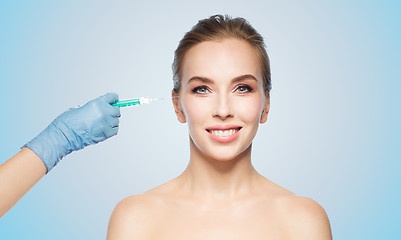 Image showing woman face and hand with syringe making injection