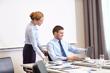 Image showing businessman and secretary with laptop in office