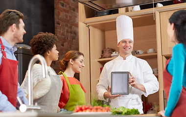 Image showing happy friends with tablet pc in kitchen