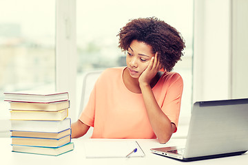 Image showing bored african american woman doing homework home