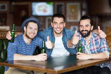 Image showing happy male friends drinking beer at bar or pub