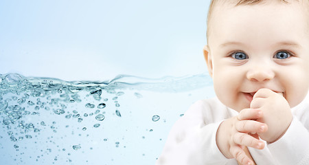 Image showing happy baby over blue background with water splash