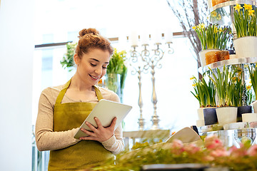 Image showing woman with tablet pc computer at flower shop