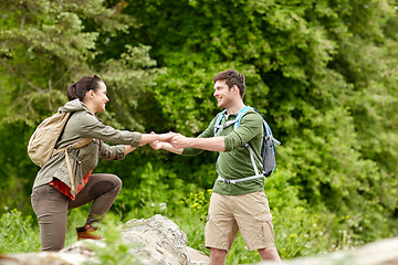 Image showing smiling couple with backpacks hiking