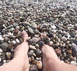 Image showing male feet and pebbles