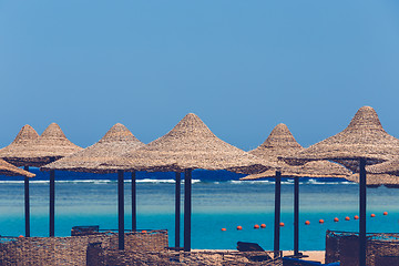 Image showing Beach umbrellas and blue sky background