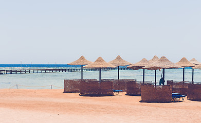 Image showing Beach umbrellas and blue sky background