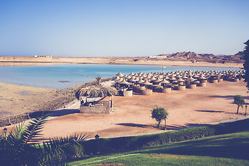 Image showing Beach umbrellas and blue sky background