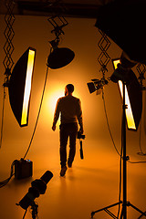 Image showing Silhouette of photographer and studio shot as workplace