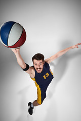 Image showing Full length portrait of a basketball player with ball