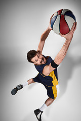 Image showing Full length portrait of a basketball player with ball