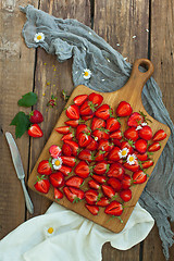 Image showing Fresh strawberry fruits, flowers, leaves on white wood table background