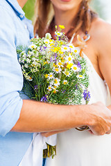 Image showing The crop image of romantic couple with flowers