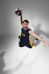 Image showing Full length portrait of a basketball player with ball