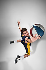 Image showing Full length portrait of a basketball player with ball