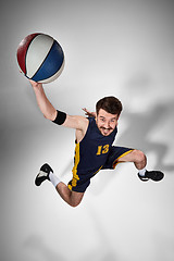 Image showing Full length portrait of a basketball player with ball