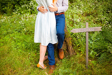 Image showing The crop image of romantic couple with green grass