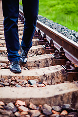 Image showing The man walking on the railway sleepers