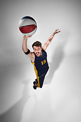 Image showing Full length portrait of a basketball player with ball