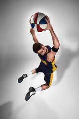 Image showing Full length portrait of a basketball player with ball