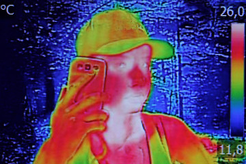 Image showing Infrared image showing the heat emission when Young girl used sm