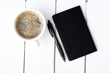 Image showing Smartphone with notebook and cup of strong coffee