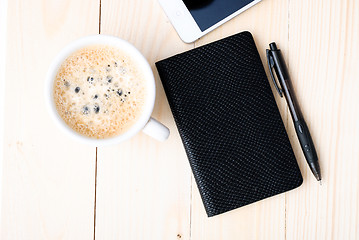 Image showing Smartphone with notebook and cup of strong coffee