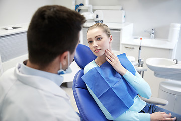 Image showing male dentist with woman patient at clinic