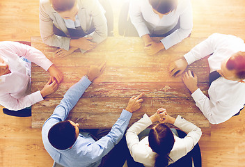 Image showing close up of business team sitting at table