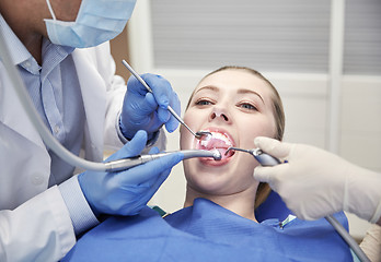 Image showing close up of dentist treating female patient teeth