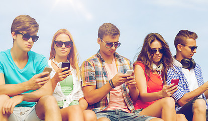 Image showing group of friends with smartphones outdoors