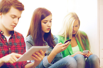 Image showing students looking into devices at school