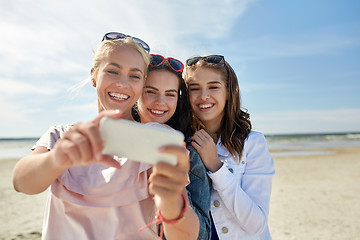 Image showing group of smiling women taking selfie on beach