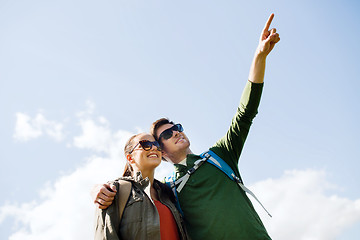 Image showing happy couple with backpacks hiking outdoors