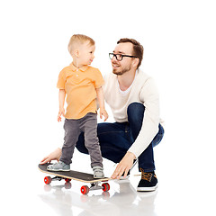 Image showing happy father and little son on skateboard