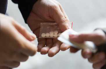 Image showing close up of addict buying dose from drug dealer