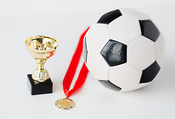 Image showing close up of football ball, golden cup and medal