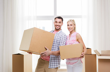 Image showing couple with big cardboard boxes moving to new home