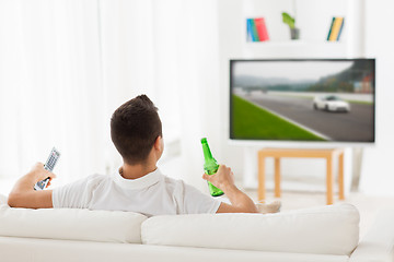 Image showing man watching tv and drinking beer at home