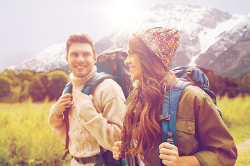 Image showing smiling couple with backpacks hiking