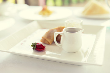 Image showing close up of pancakes and honey or jam on plate