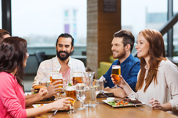 Image showing friends dining and drinking beer at restaurant