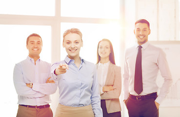 Image showing businesswoman in office pointing finger at you