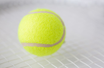 Image showing close up of tennis racket with ball