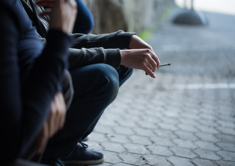 Image showing close up of young men smoking cigarettes