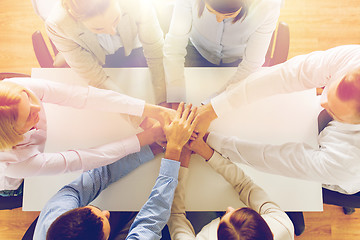 Image showing close up of business team with hands on top