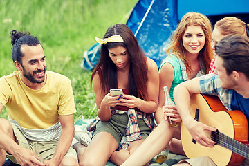 Image showing happy friends with drinks and guitar at camping