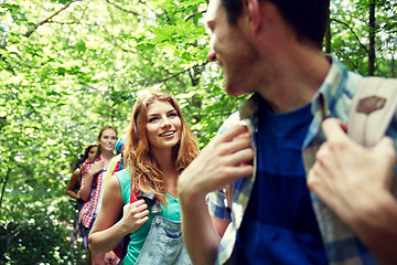 Image showing group of smiling friends with backpacks hiking