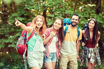 Image showing group of smiling friends with backpacks hiking