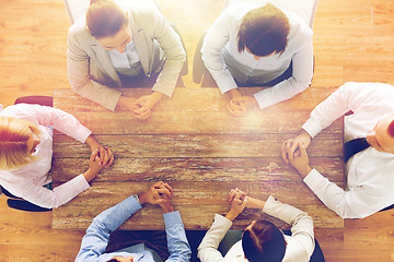 Image showing close up of business team sitting at table